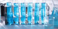 row of test tubes containing a blue liquid - decorative